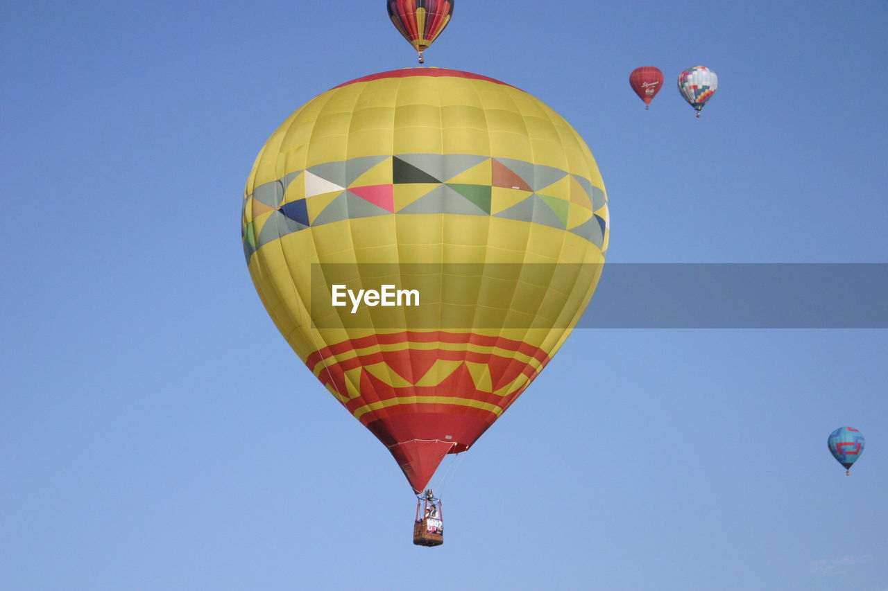 Low angle view of hot air balloon against blue sky