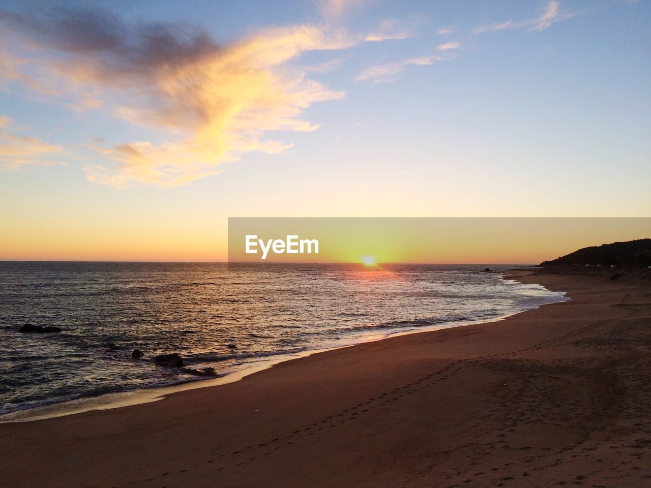 Scenic view of beach and sea against sky during sunset 