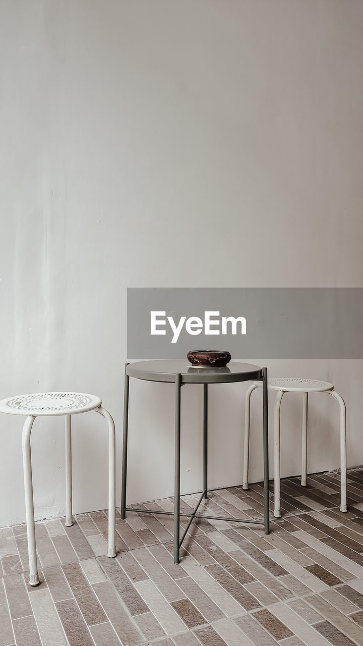 floor, seat, chair, table, indoors, furniture, flooring, white, no people, wood, coffee table, wall - building feature, copy space, room, absence, home interior, wall, interior design, architecture, lighting, domestic room, empty