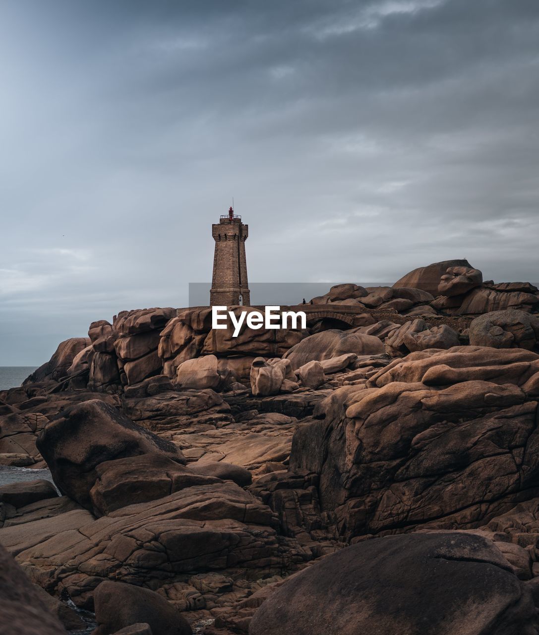 Rock formation by building against sky