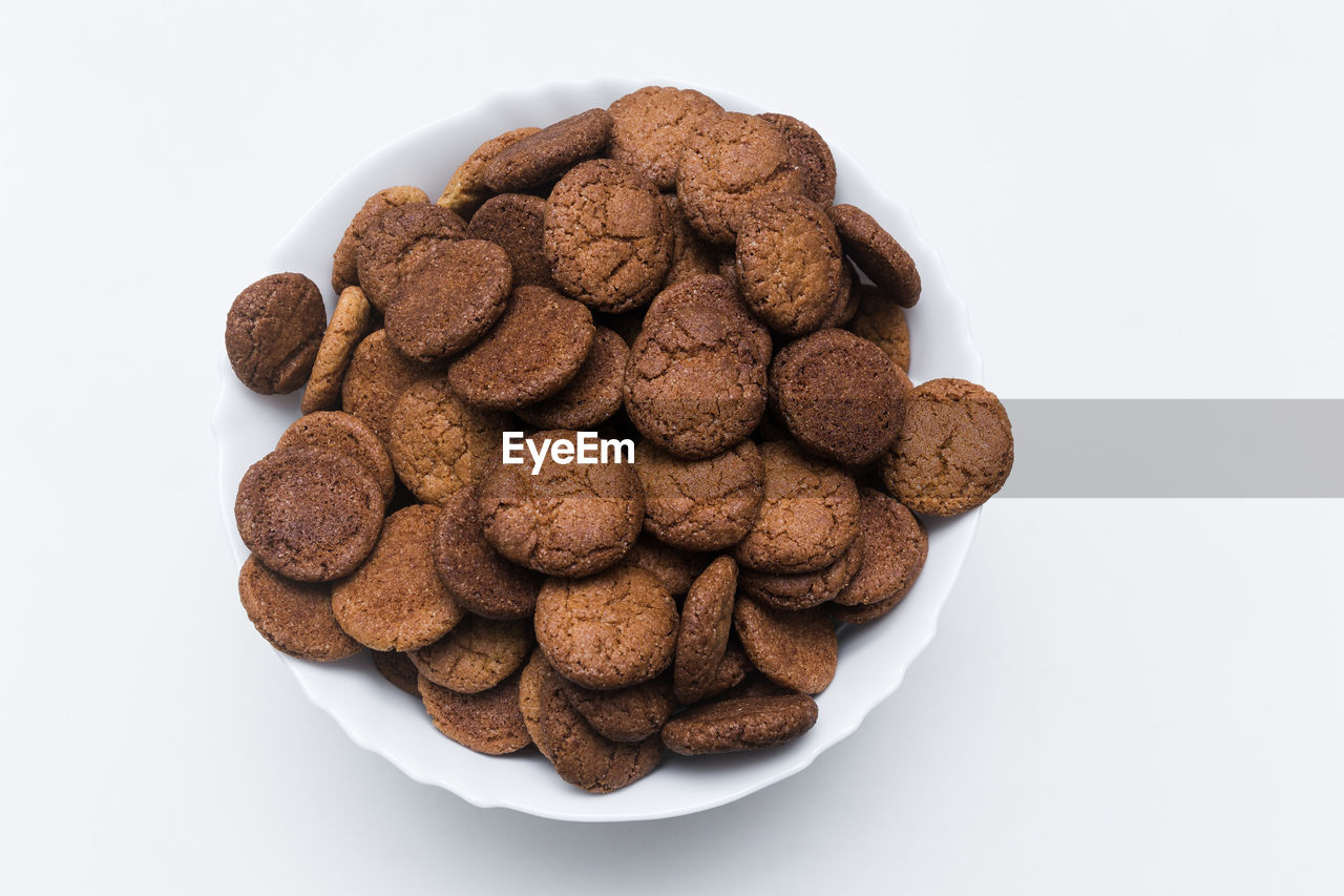 Close-up of cookies in bowl on white background
