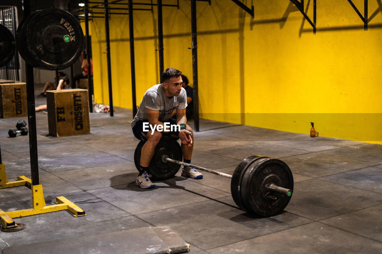 Side view of man exercising in crossfit gym