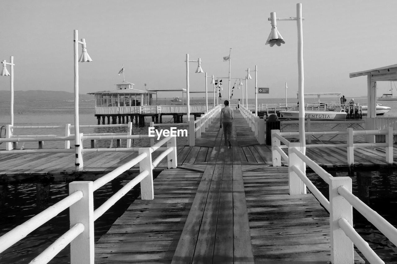 WOODEN PIER OVER SEA AGAINST SKY