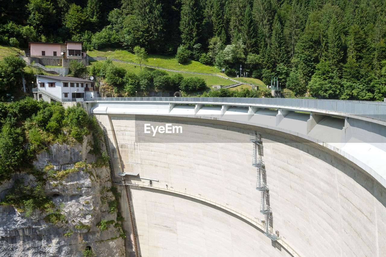 HIGH ANGLE VIEW OF DAM BY TREES
