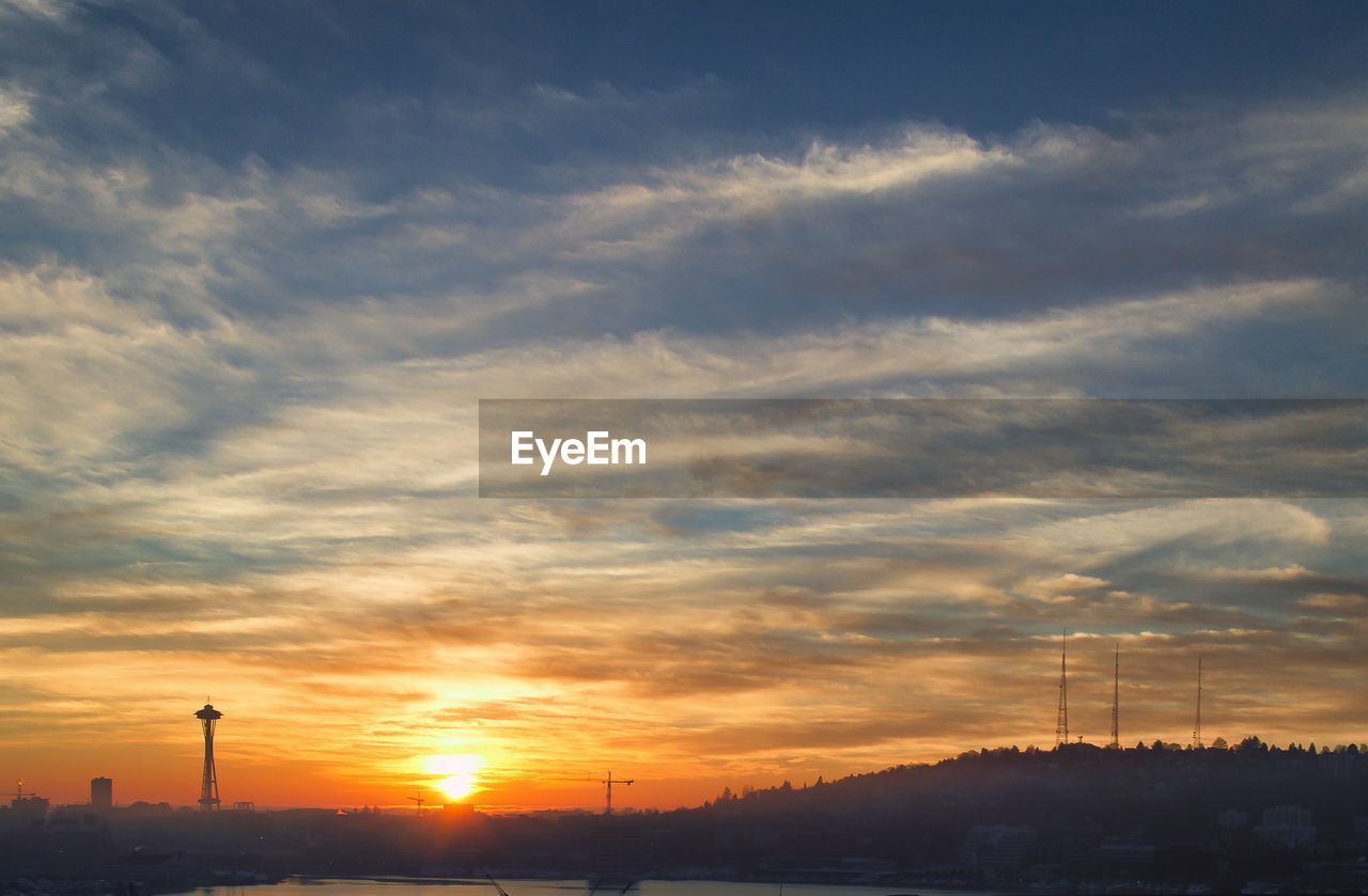 Silhouette space needle against sunset sky