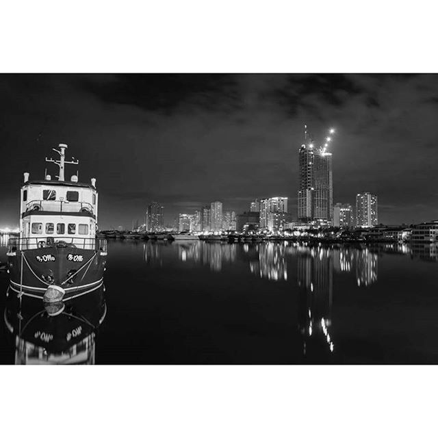 VIEW OF ILLUMINATED CITYSCAPE AT NIGHT