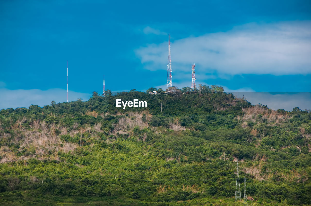 LOW ANGLE VIEW OF COMMUNICATIONS TOWER AGAINST BLUE SKY