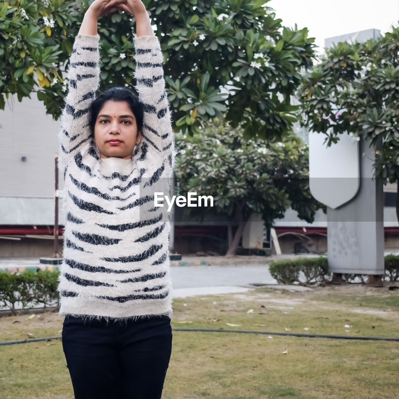 Portrait of gorgeous young indian woman practicing yoga outdoor park. beautiful girl practice yoga