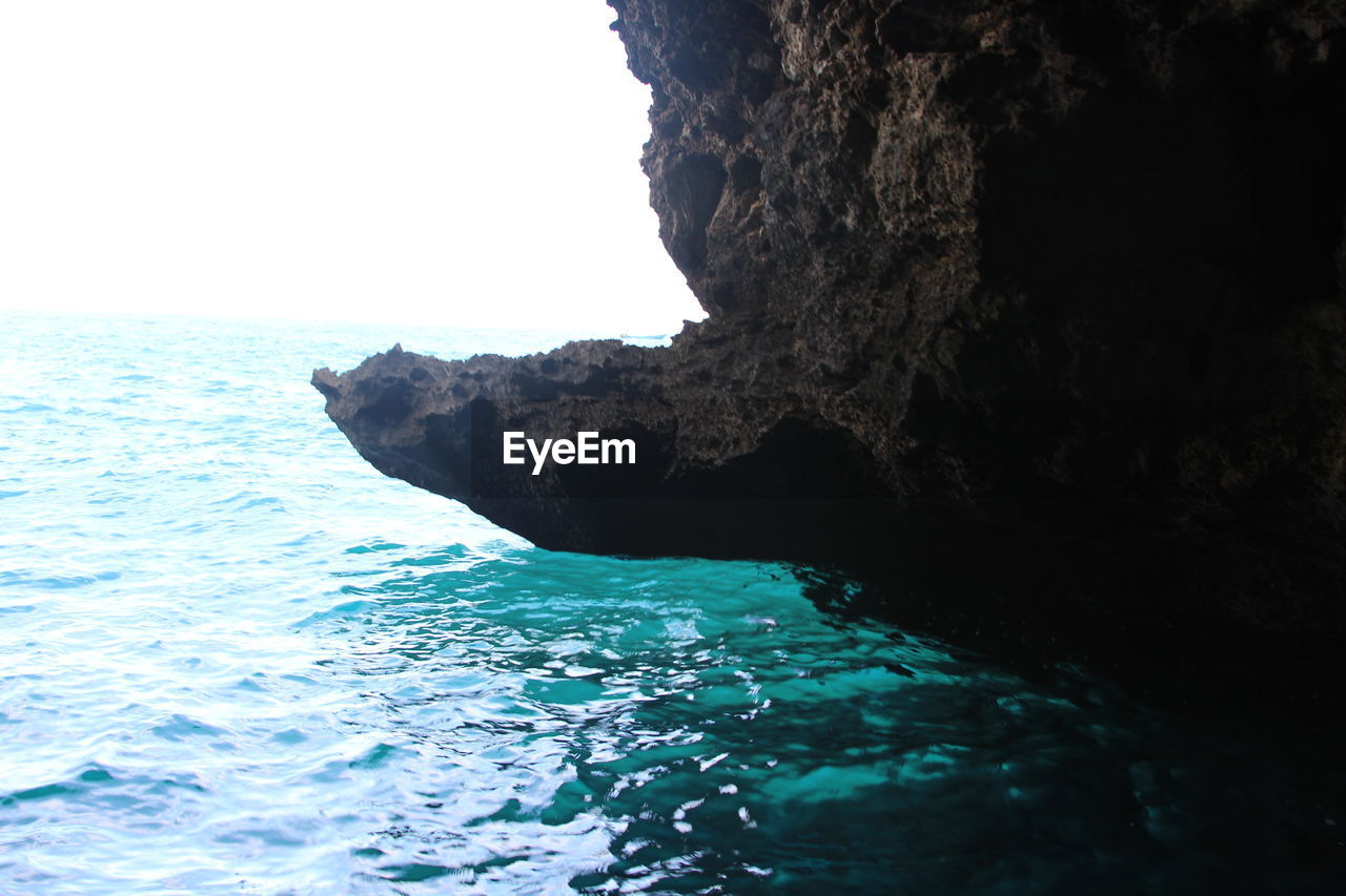 SCENIC VIEW OF SEA WITH ROCKS IN BACKGROUND