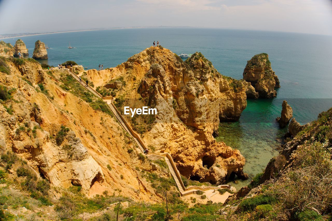 Scenic view of rocks in sea against sky