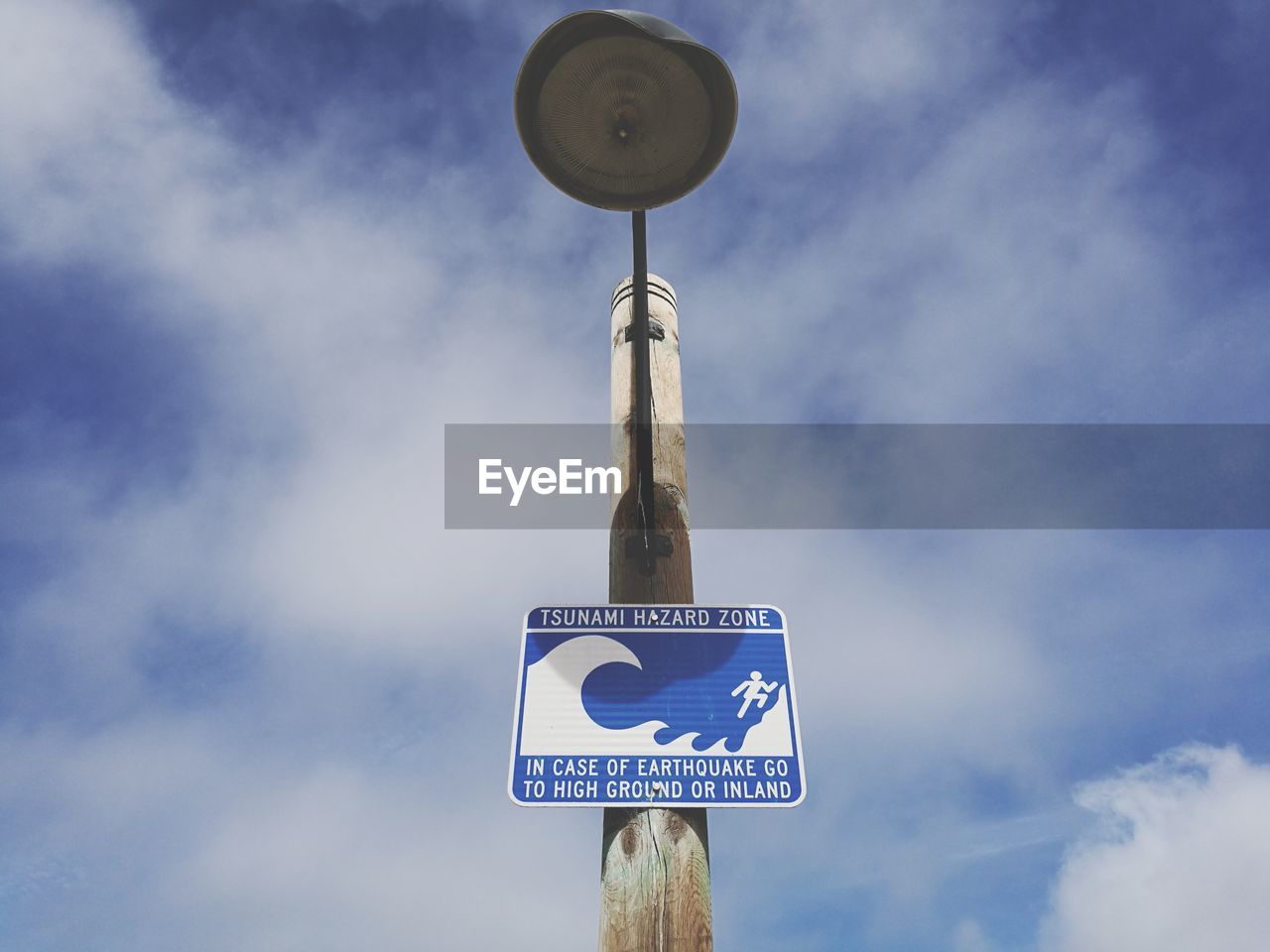 Low angle view of road sign against sky