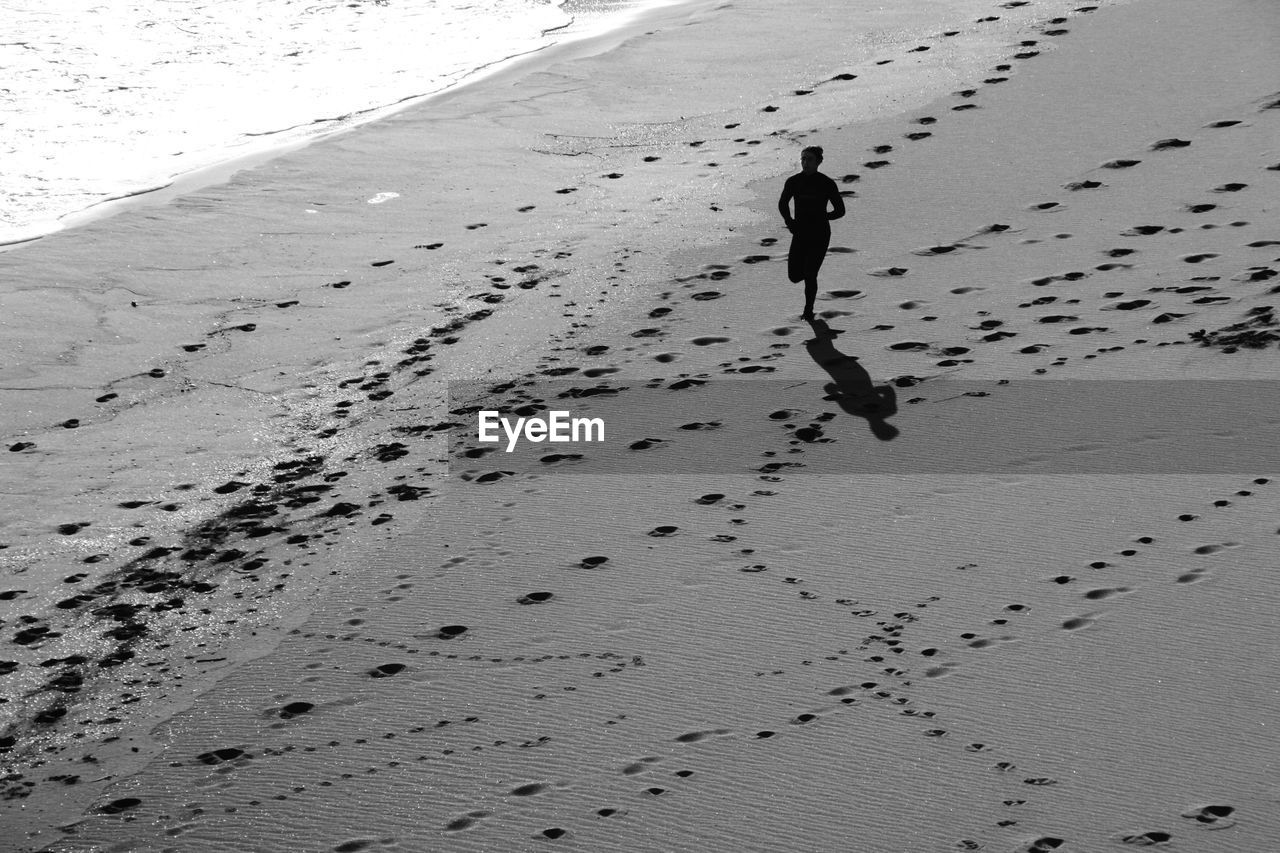 High angle view of woman running on beach