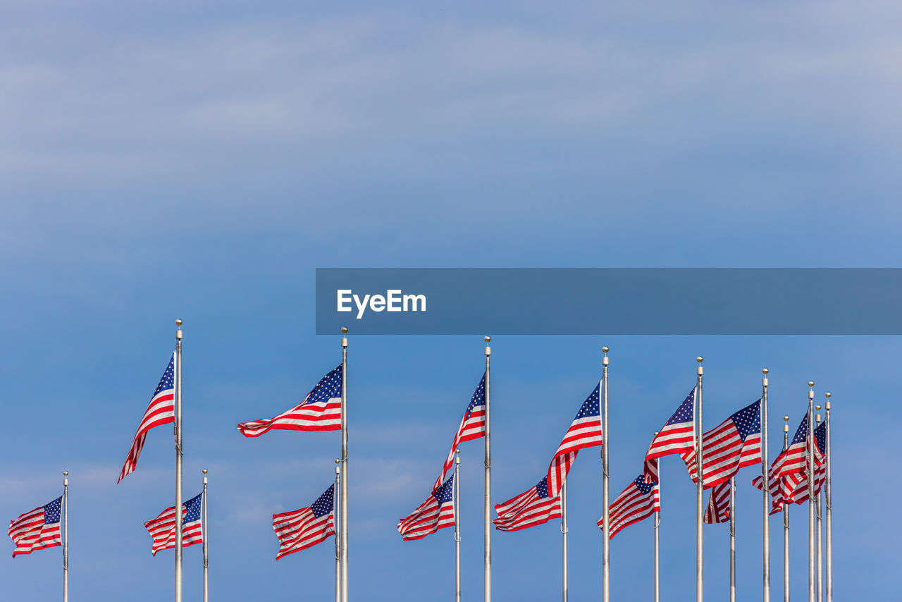 LOW ANGLE VIEW OF FLAGS FLAG AGAINST SKY