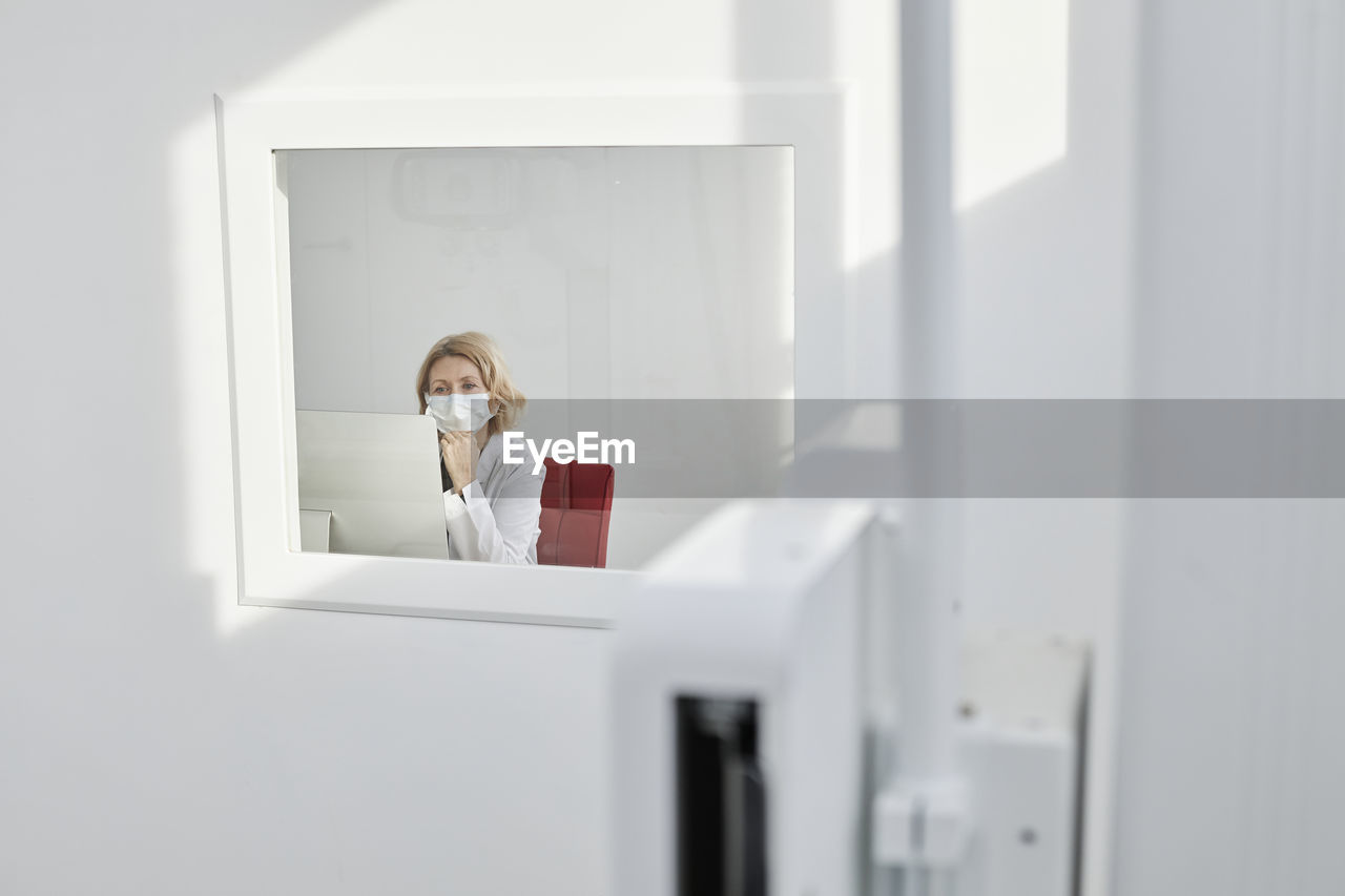 Radiologist wearing protective face mask working in clinic