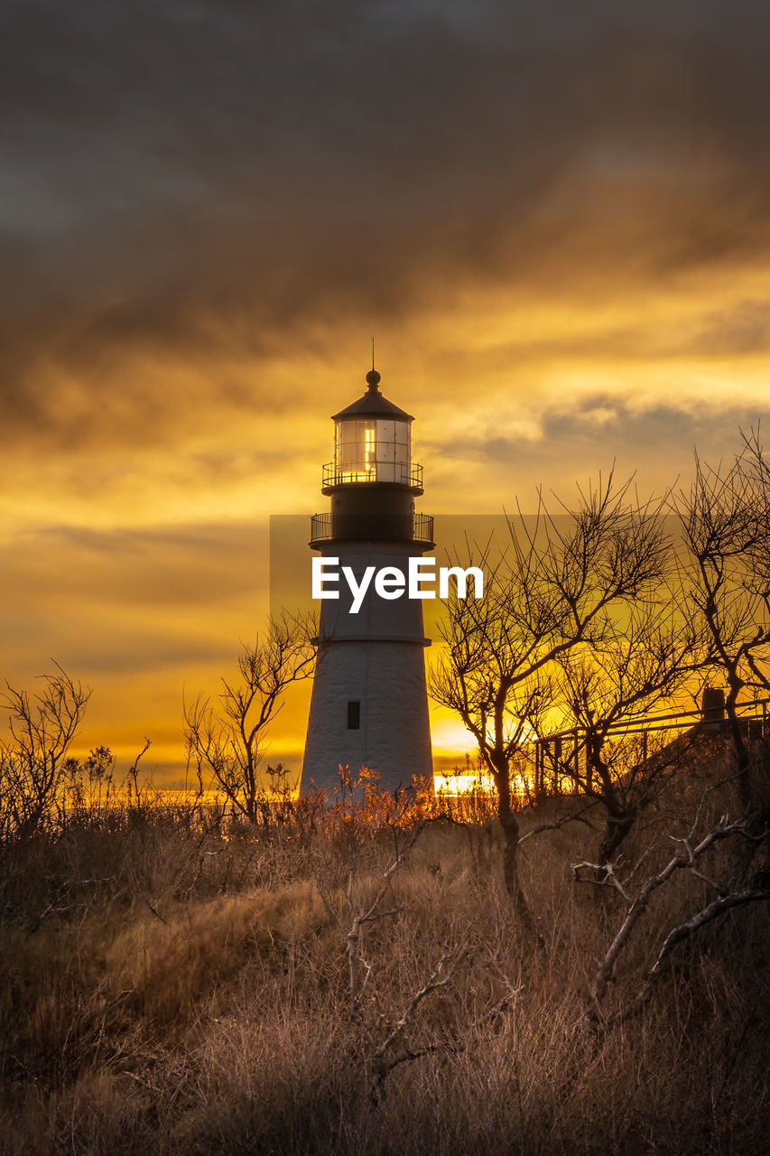 lighthouse against sky during sunset