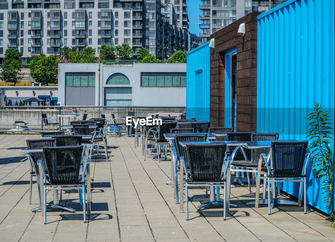 EMPTY CHAIRS AND TABLES IN BUILDING