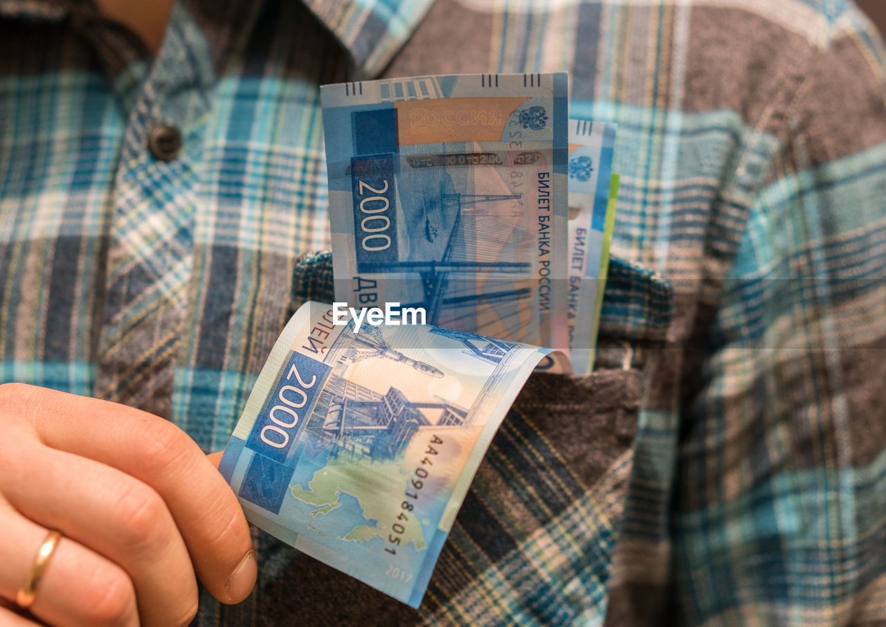 Midsection of man with money in pocket