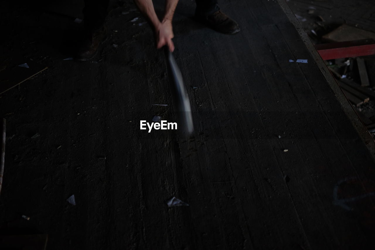 Cropped hands of man holding baseball bat