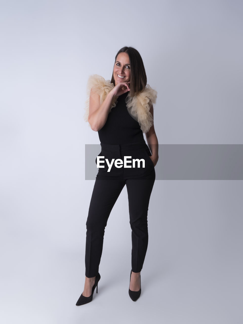 studio shot, one person, adult, full length, women, portrait, photo shoot, indoors, gray background, gray, long hair, young adult, hairstyle, clothing, emotion, human leg, looking at camera, female, fashion, standing, blond hair, white background, limb, smiling, copy space, front view, person, happiness