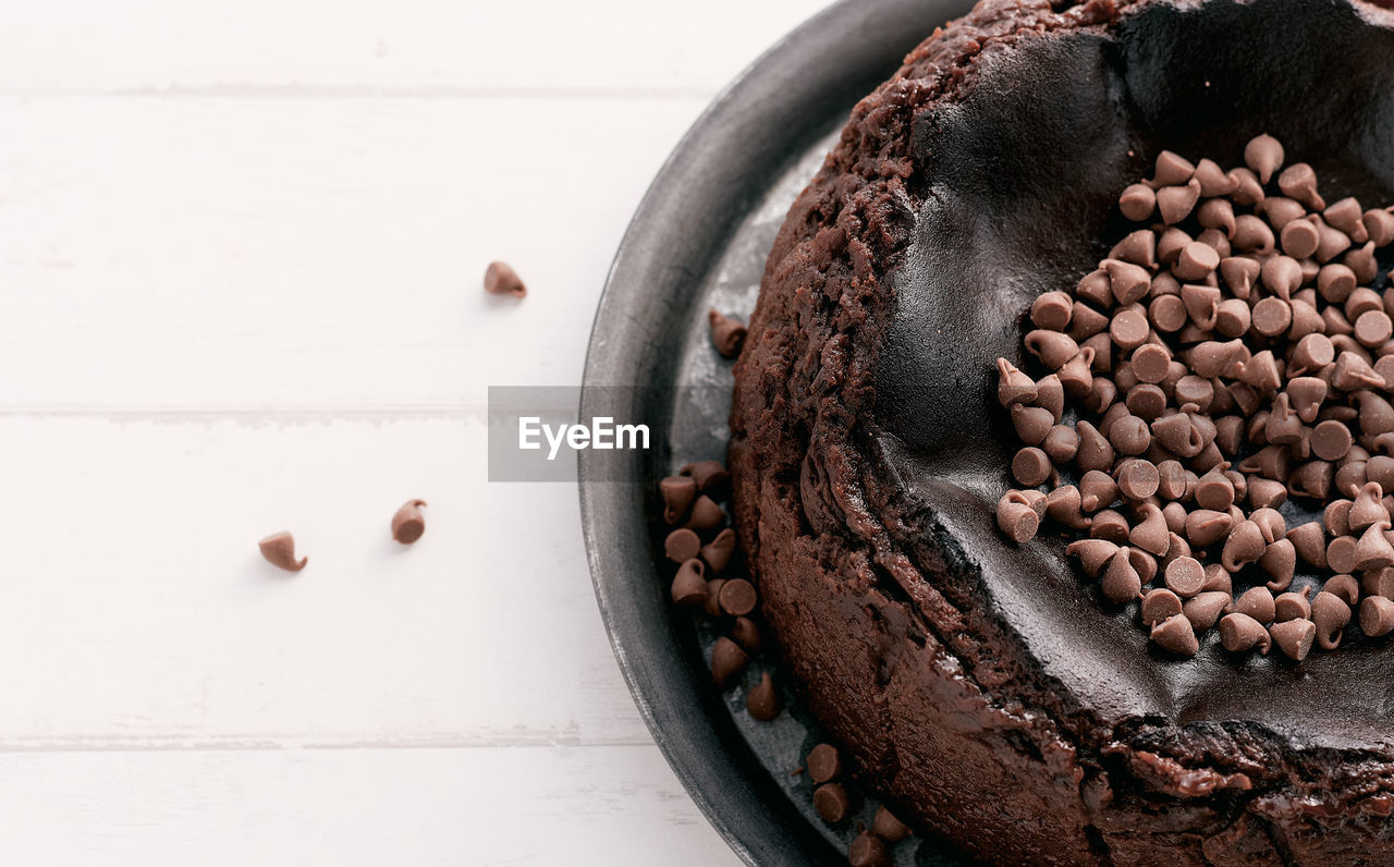 Overhead view of a chocolate basque burnt cheesecake with chocolate chips