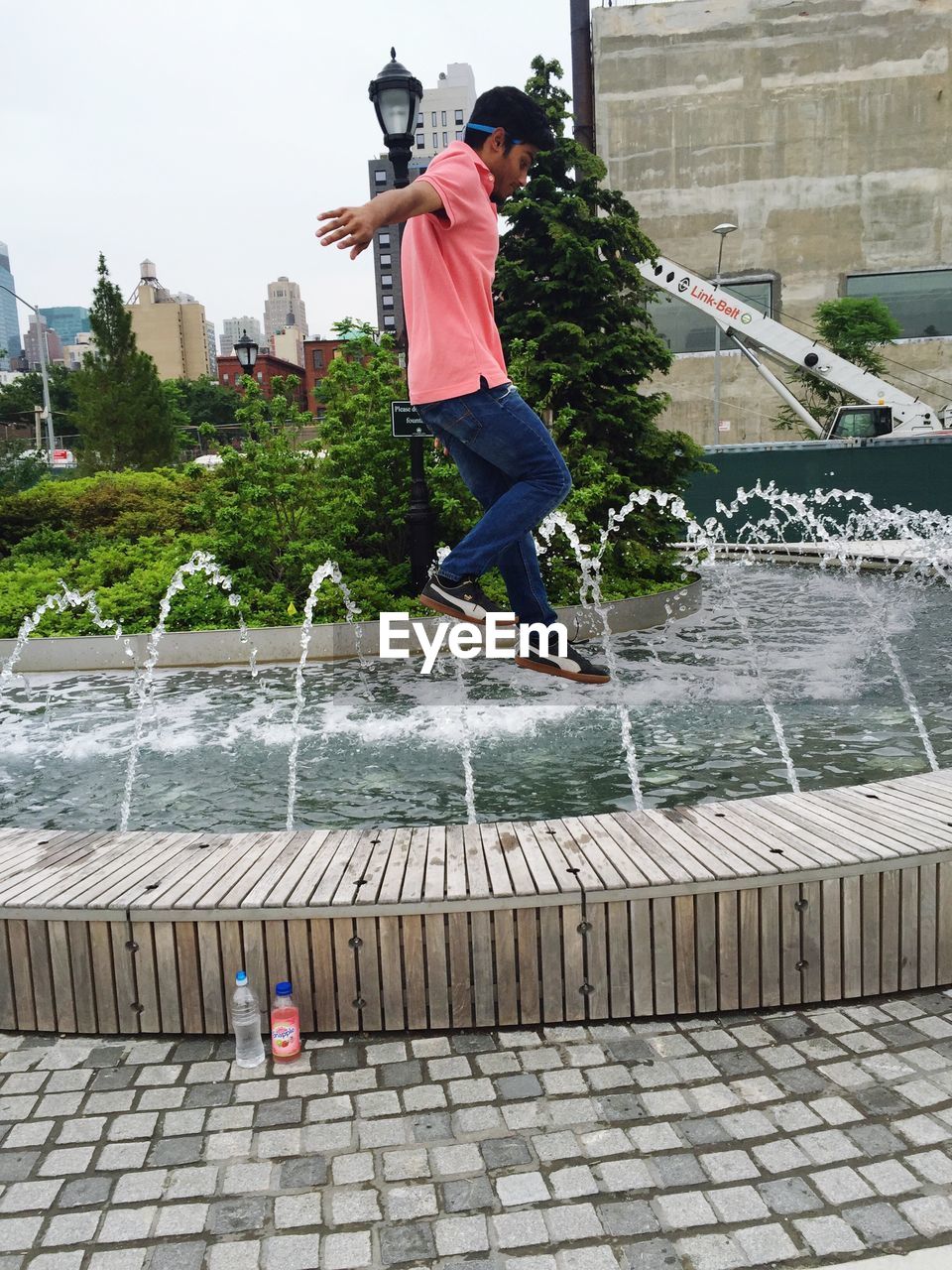 YOUNG WOMAN JUMPING IN PARK