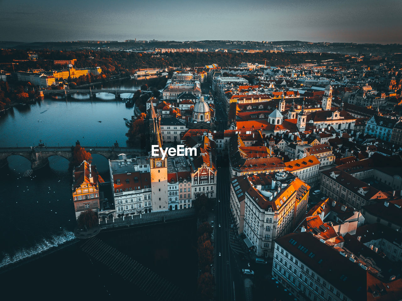 High angle view of illuminated city against sky at dusk