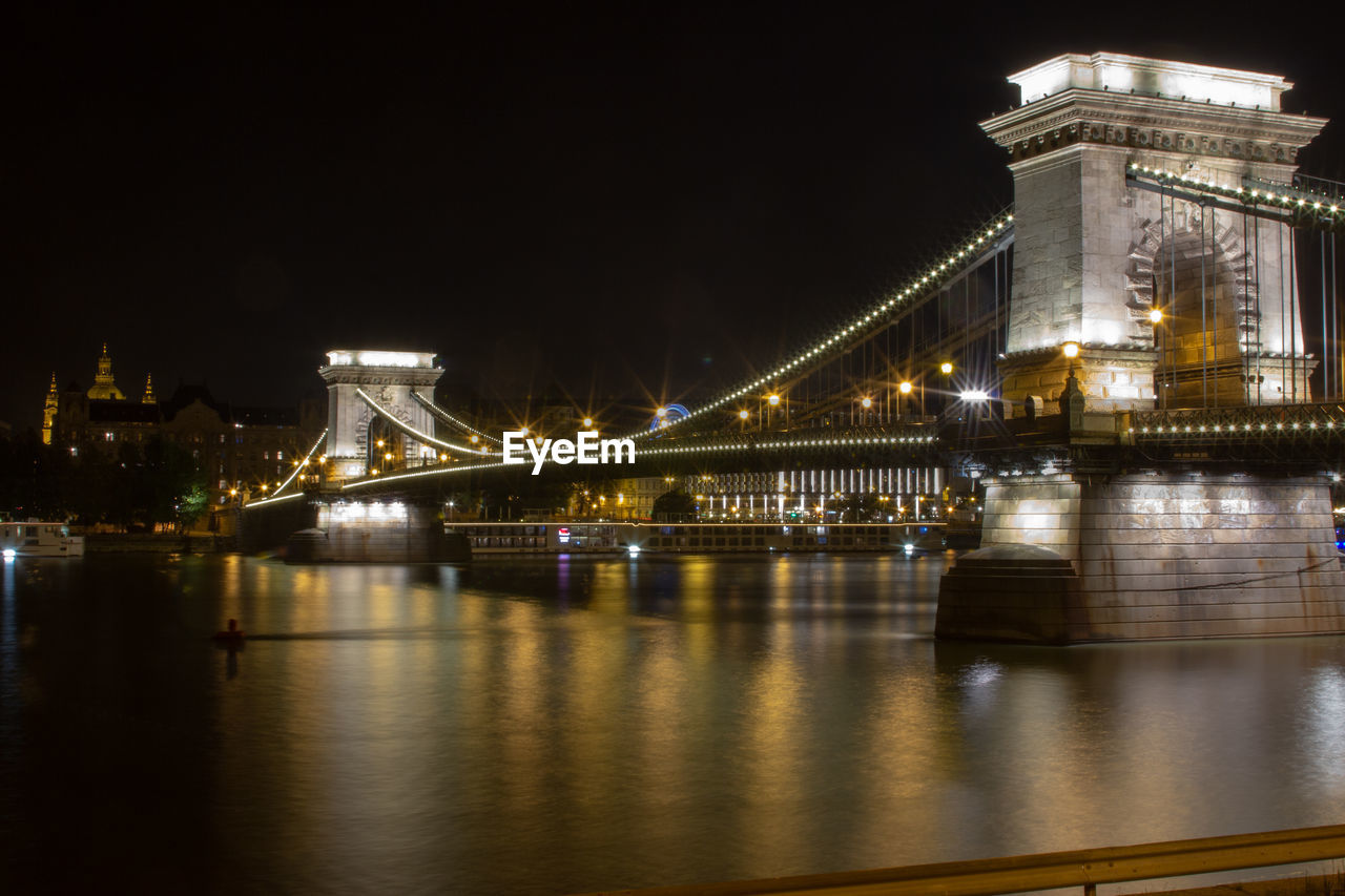 ILLUMINATED BRIDGE OVER RIVER