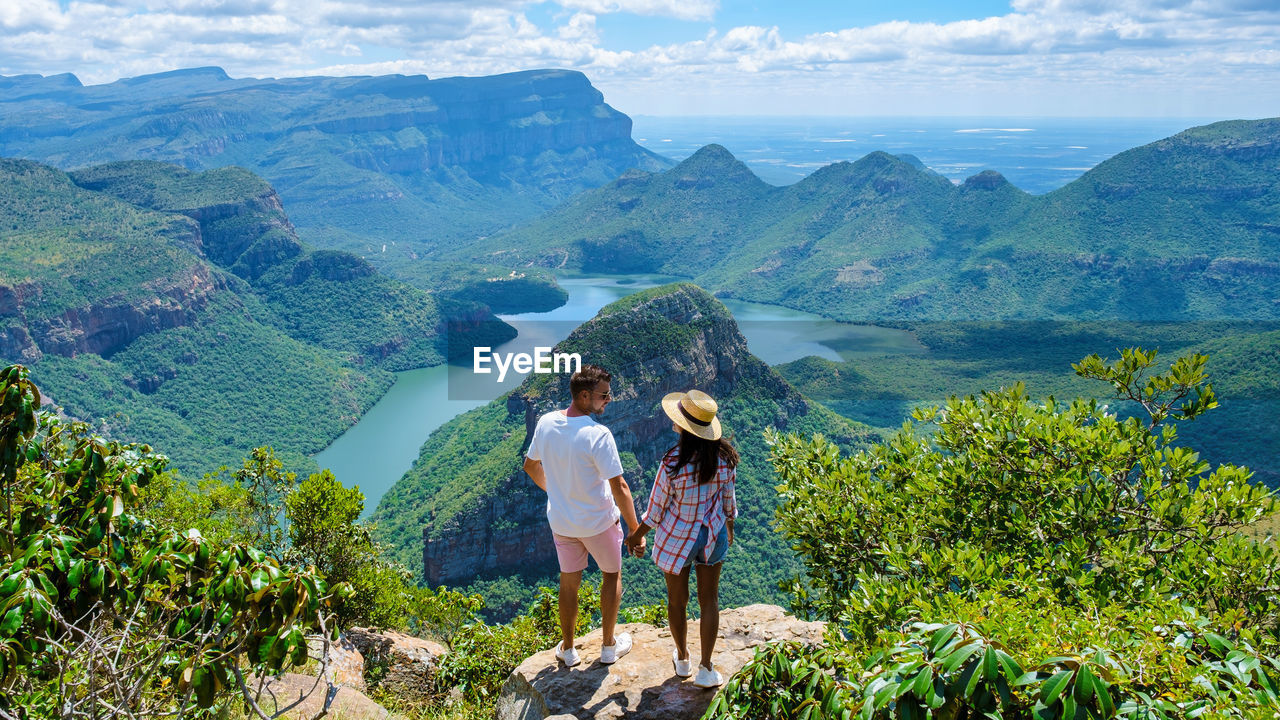 rear view of man standing on mountain