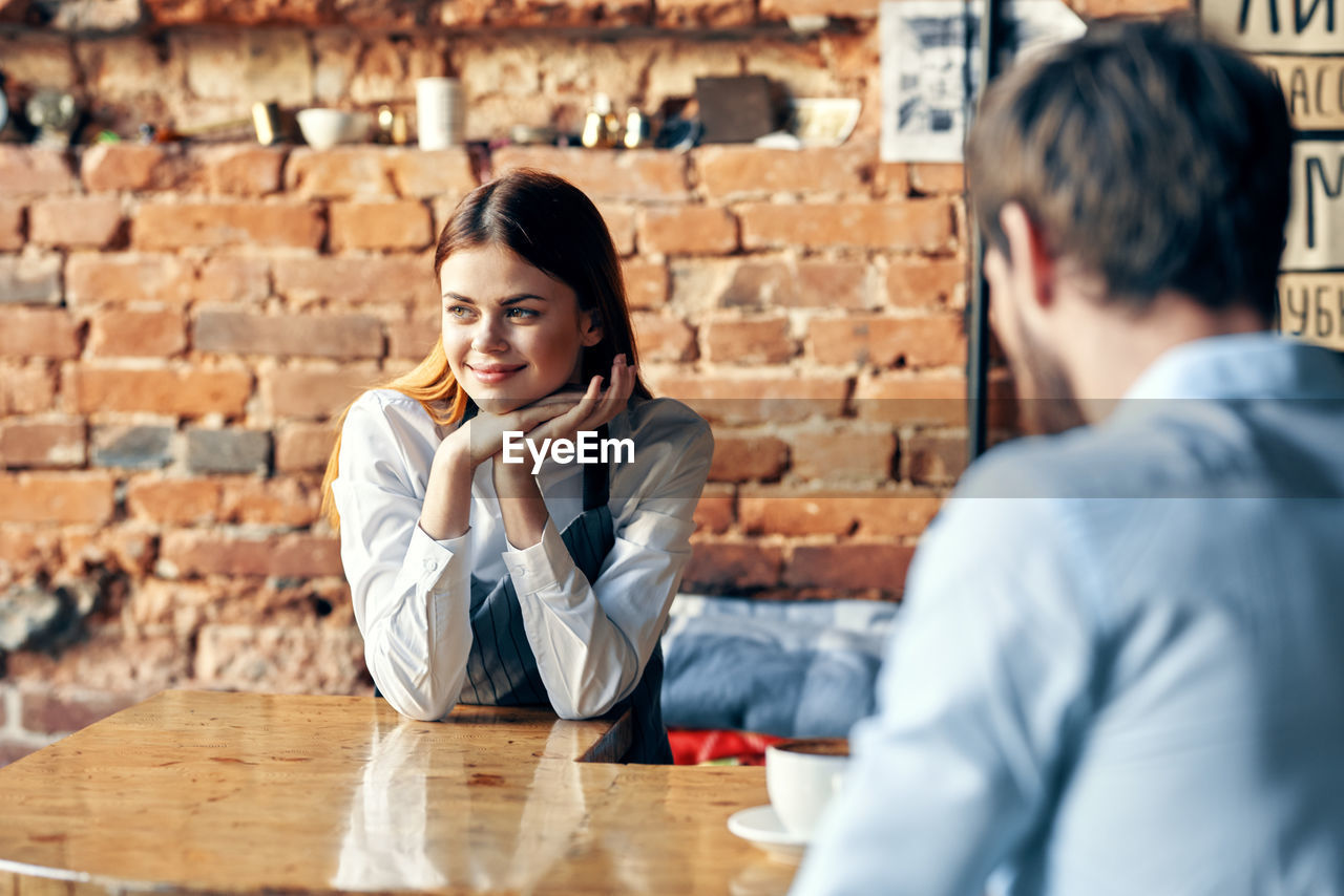 Young couple sitting on table