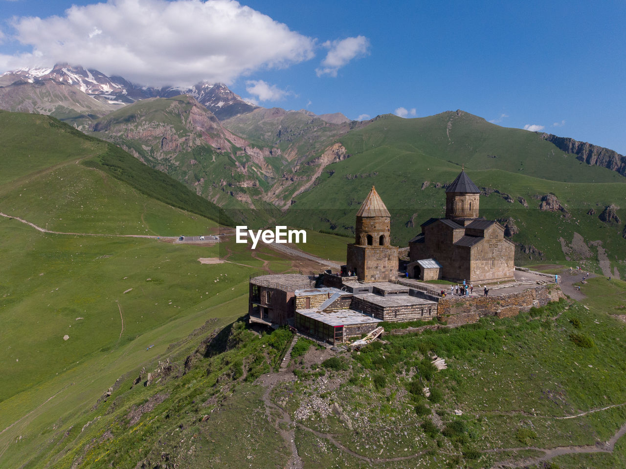 Scenic view of gergeti trinity church in front of mount kazbek against sky