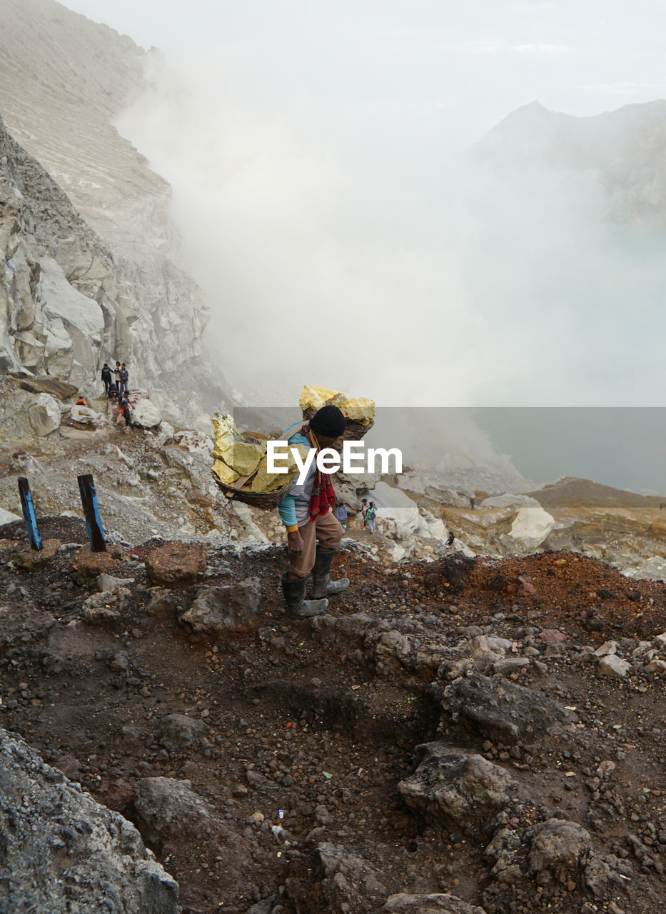 The miners carrying the sulphurs from the crater.