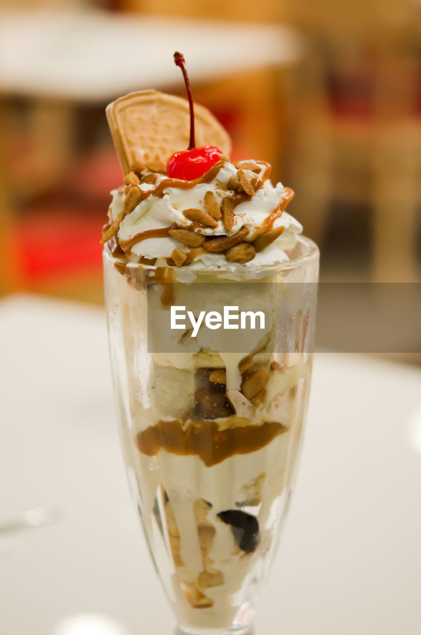 CLOSE-UP OF ICE CREAM WITH GLASS OF JUICE