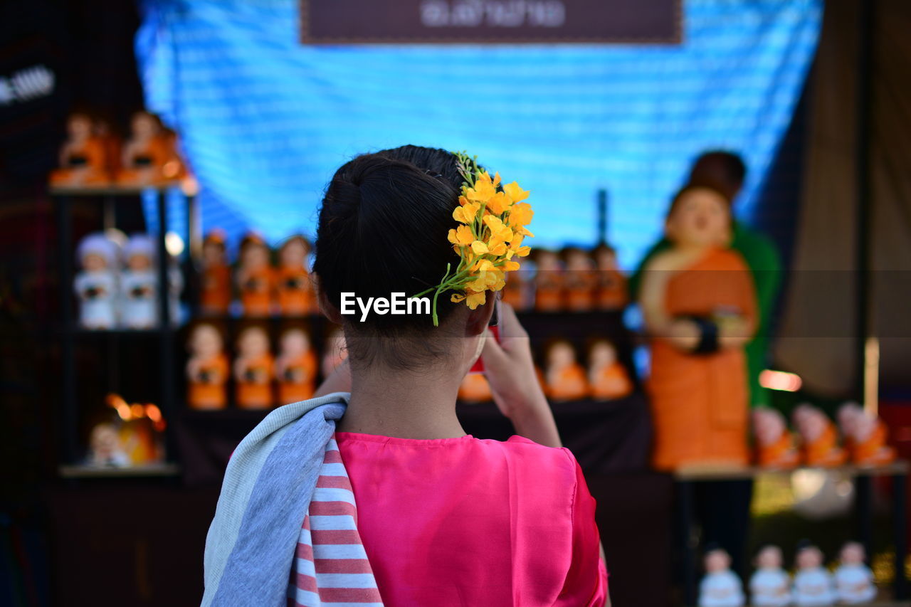 Rear view of girl wearing flowers on head