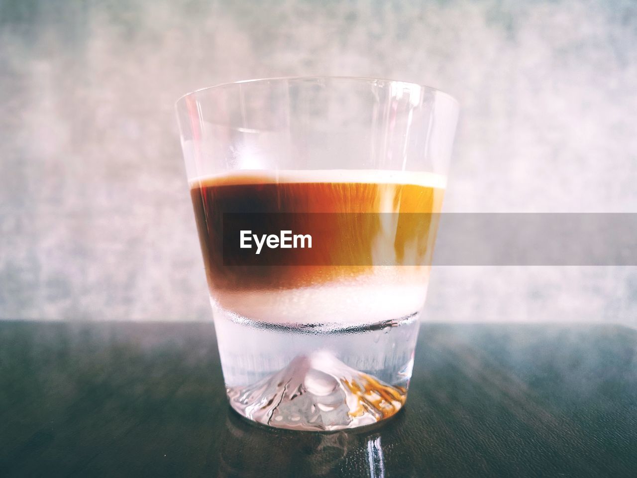 Close-up of coffee on table against wall