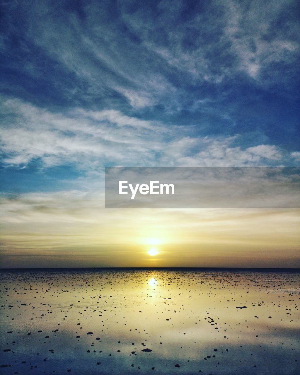 SCENIC VIEW OF BEACH AGAINST SKY DURING SUNSET