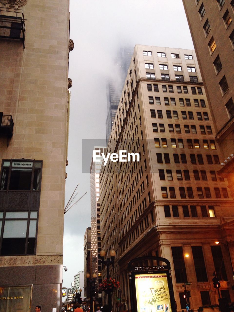 Exterior of modern buildings against sky during foggy weather