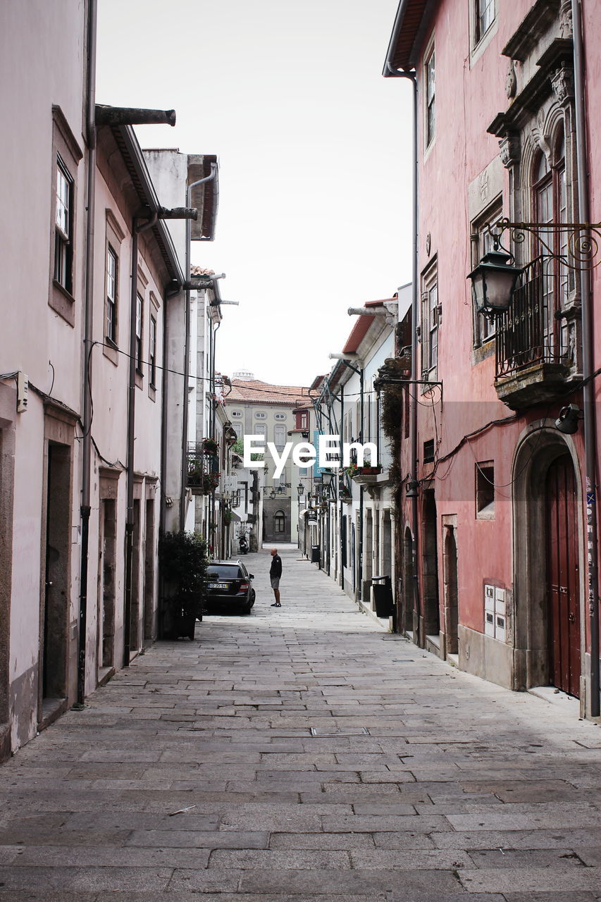 Empty alley amidst buildings in city