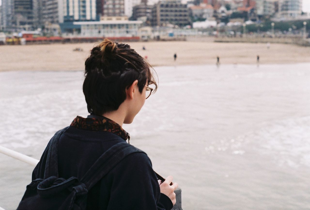 Rear view of woman on pier at beach