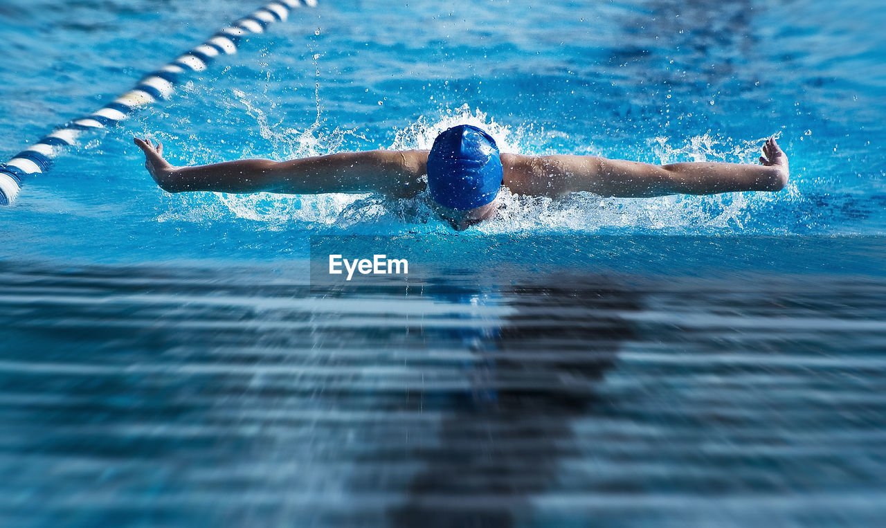 Person swimming in swimming pool