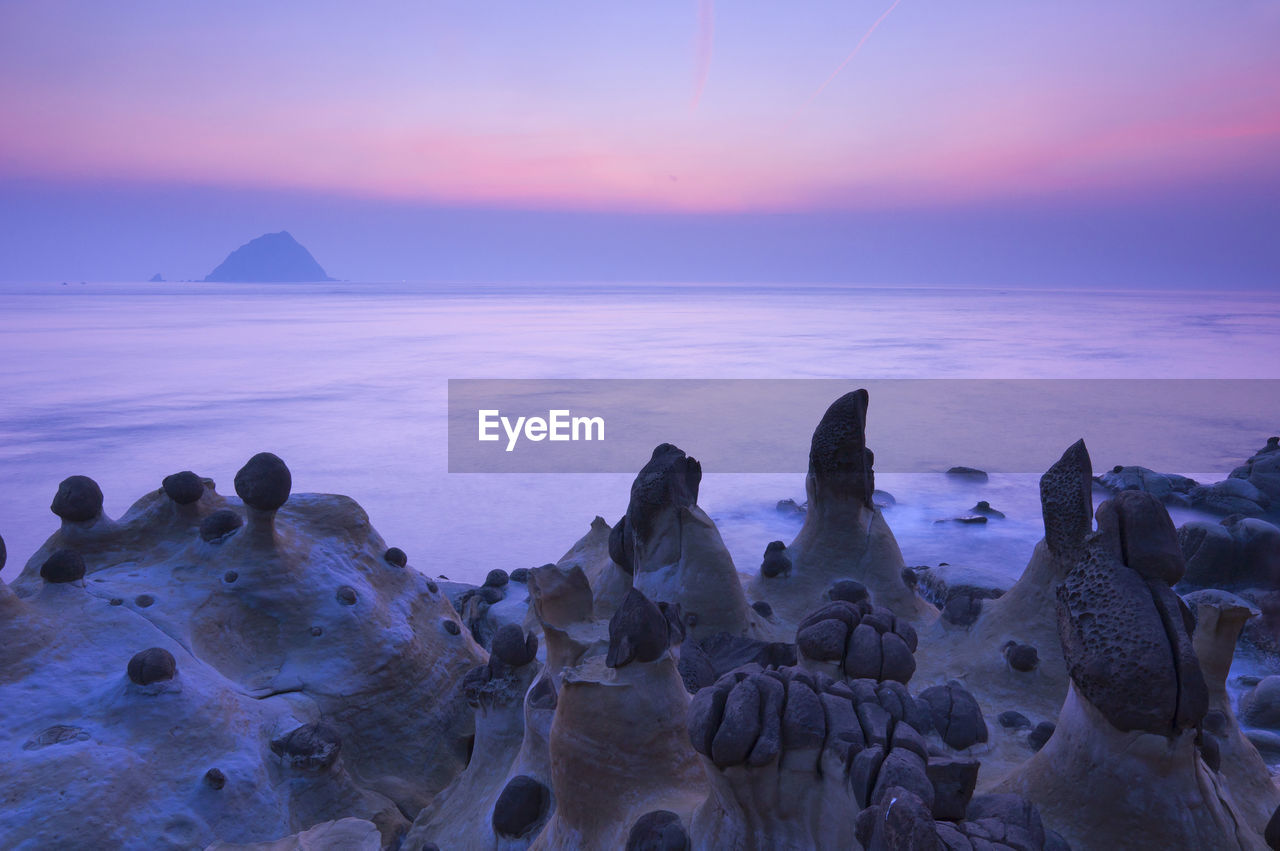 Scenic view of sea against sky at sunset