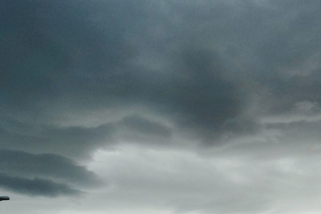 LOW ANGLE VIEW OF STORM CLOUDS OVER DRAMATIC SKY