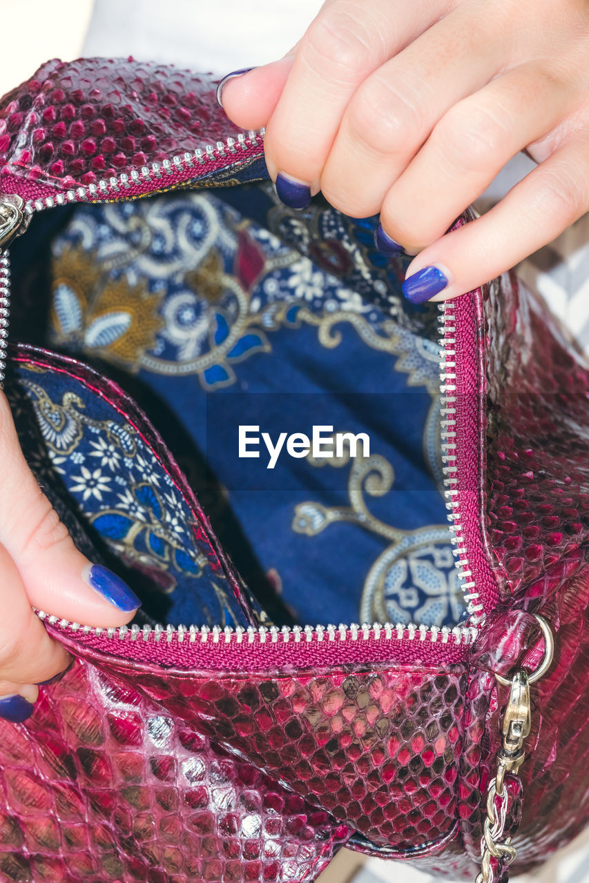 Girl holding a bag made of handmade python skin