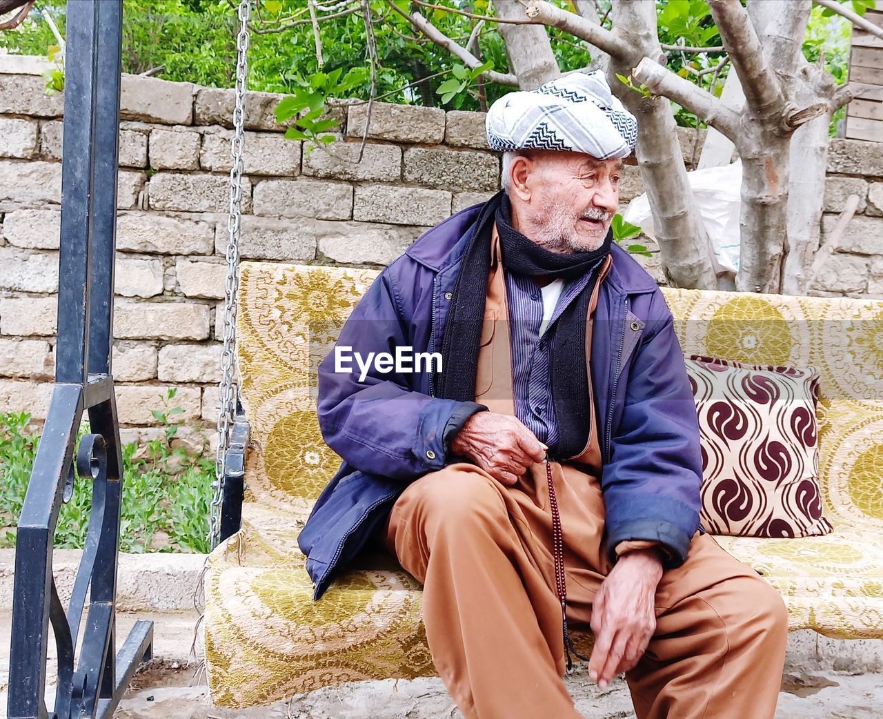 Portrait of senior man sitting outdoors