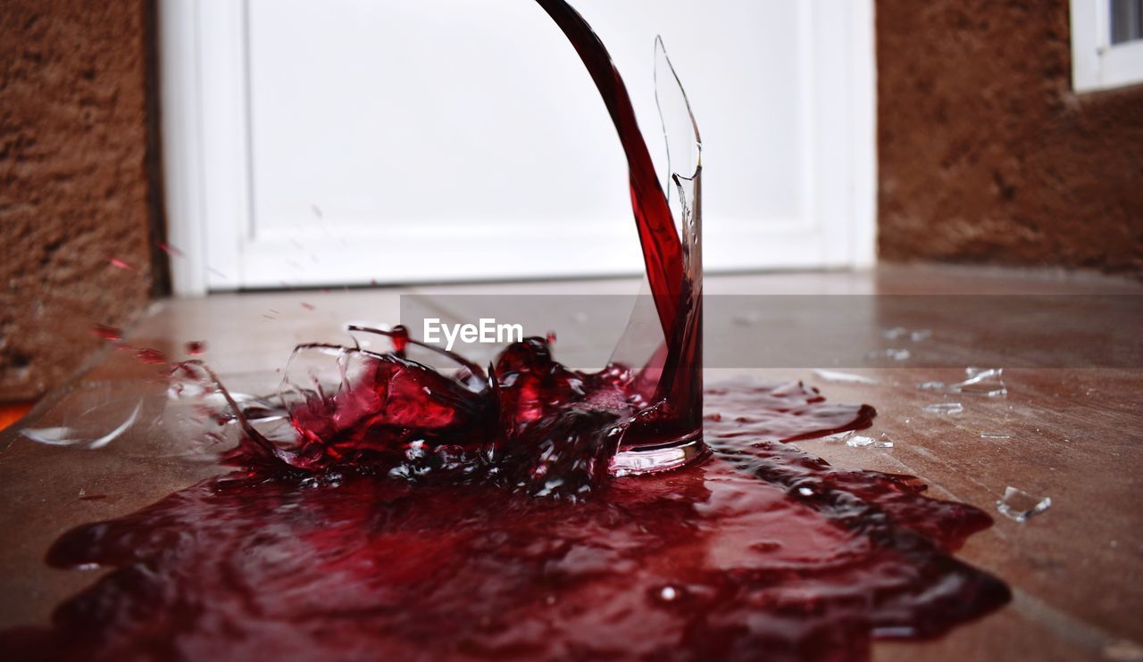 Close-up of wine splashing on table