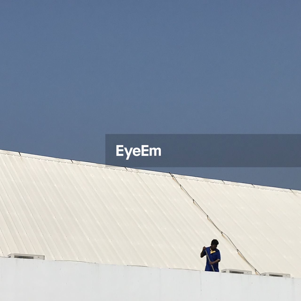 Low angle view of man working on terrace