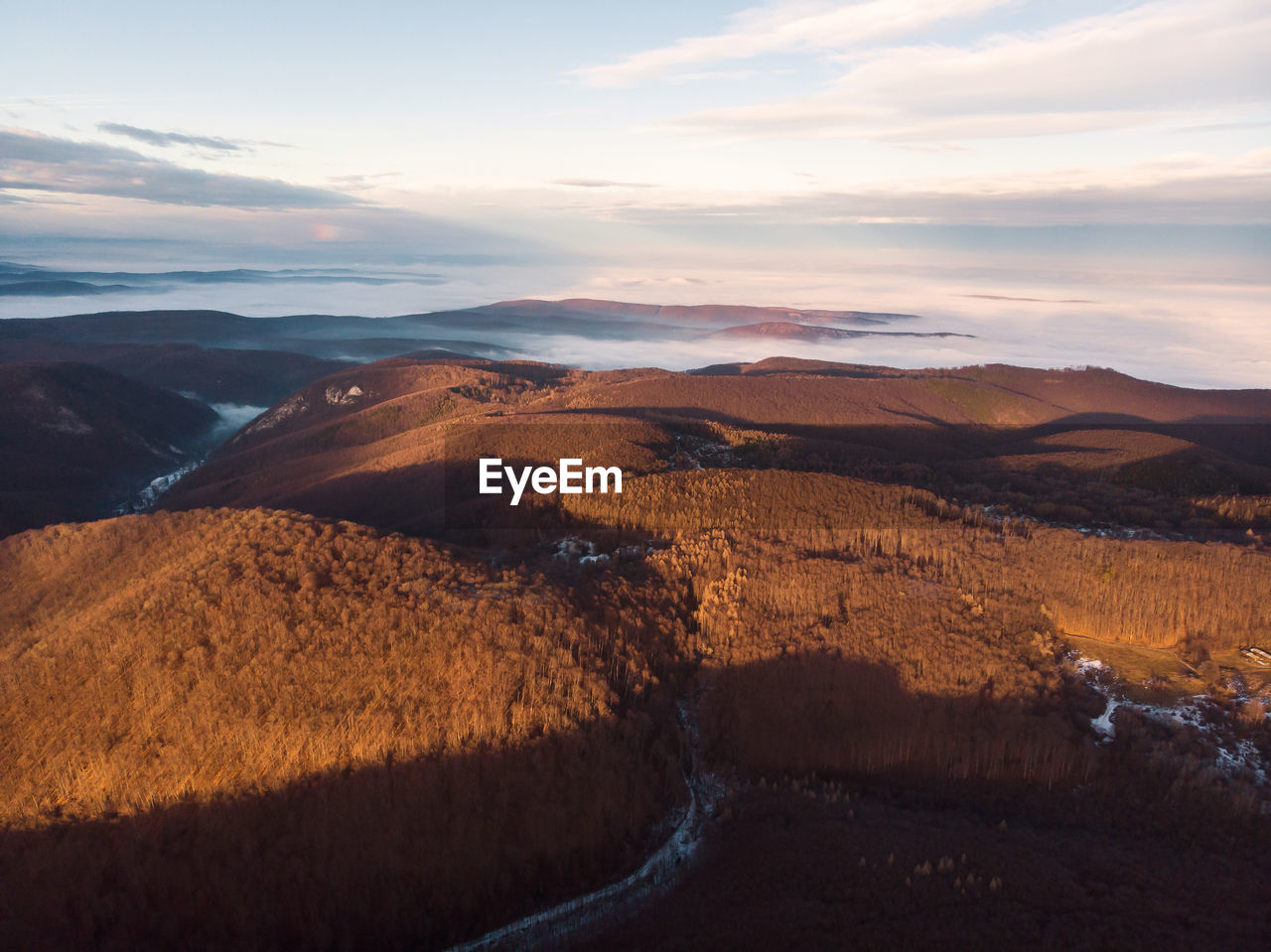 scenic view of land against sky during sunset