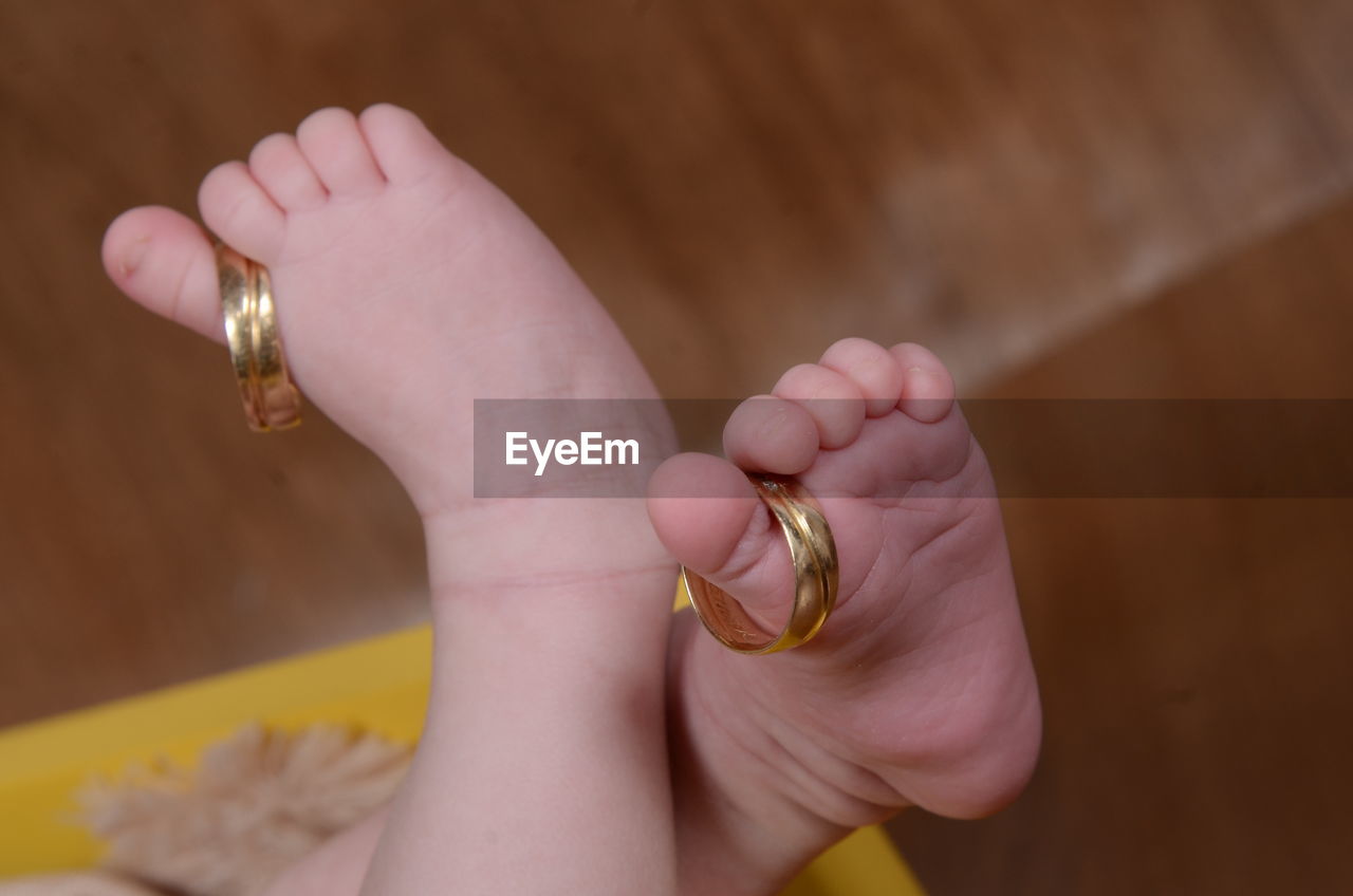 Low section of baby with rings at home