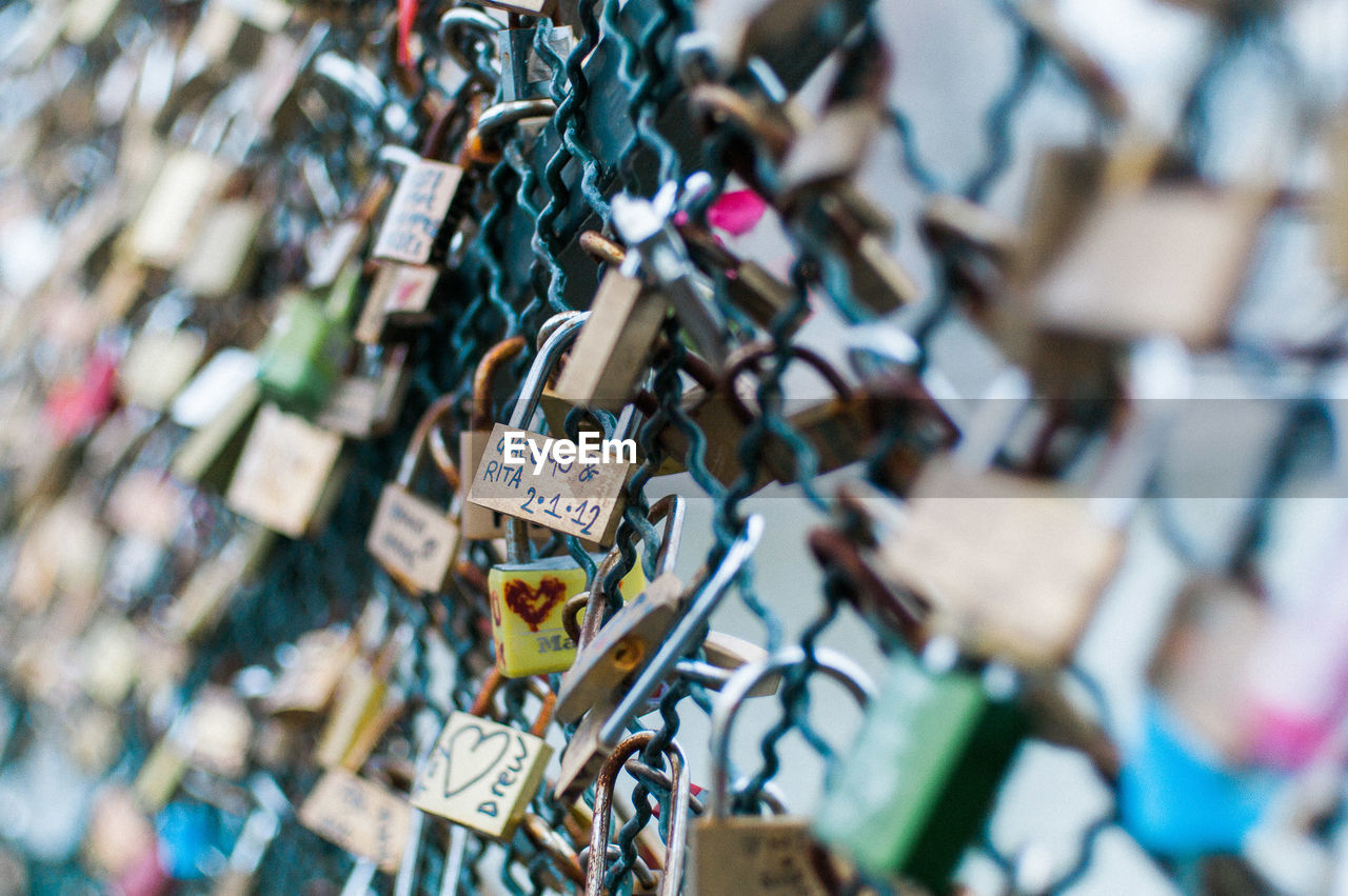 CLOSE-UP OF LOVE PADLOCKS ON RAILING