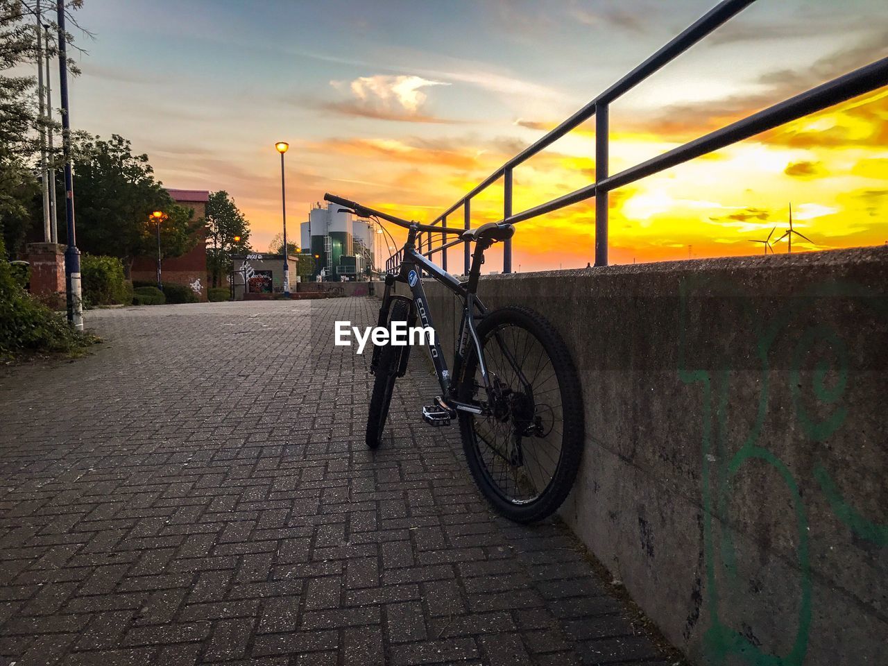 BICYCLE ON ROAD AGAINST SKY