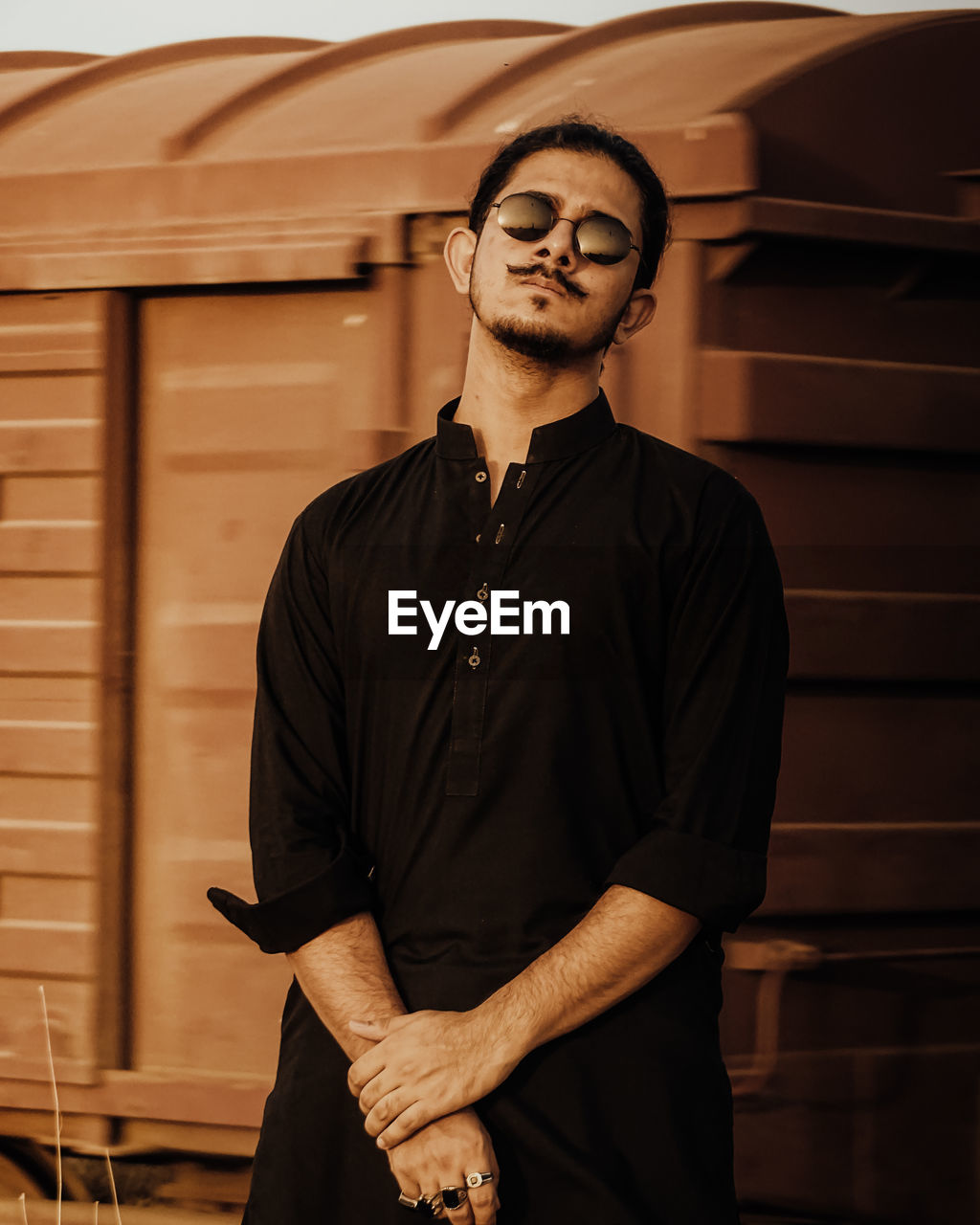 Young man wearing sunglasses standing outdoors